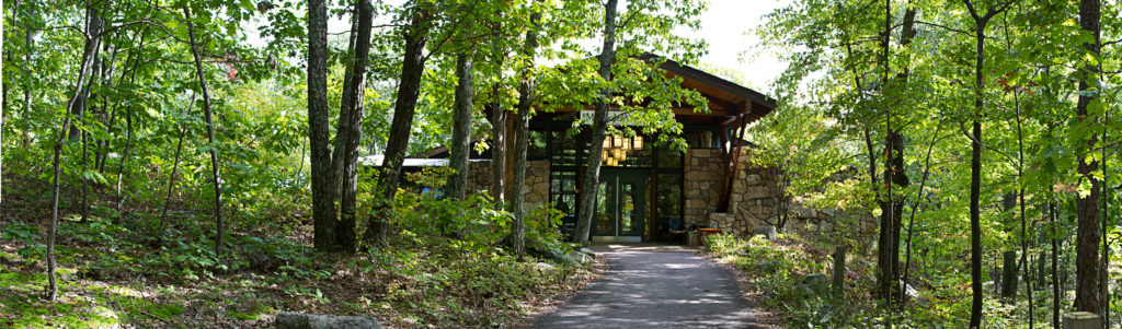 Mohonk Preserve Visitor Center front doors, a path leading to it through the forest