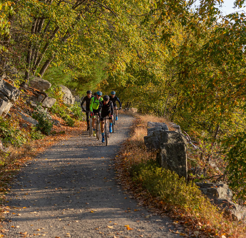 Four bikers ride on Undercliff Carriage Road in a "V" formation