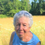 Anka Angrist on a nature walk in front of a field