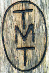 TMT logo burned into wood