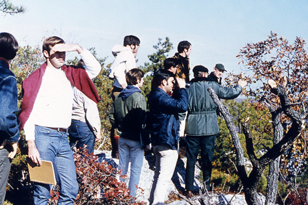 A group of students and researchers survey the land