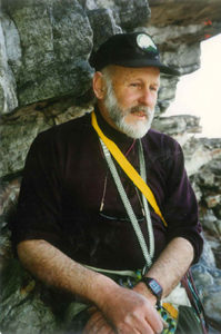 Ranger Thom Scheuer sitting on a cliff.