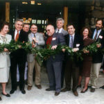 A group of people in front of the Mohonk Preserve visitor center cutting a ribbon