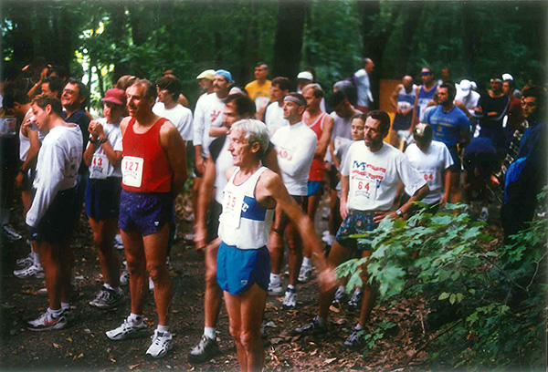 A crowd of runners in the forest prepare for the Pfalz Point Trail Challenge
