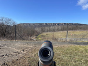 Binocular scope pointed at the Gunks on a blue sky winter's day