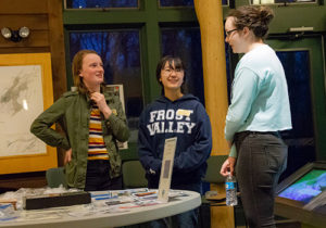 Three individuals gather at the Mohonk Preserve Visitor Center