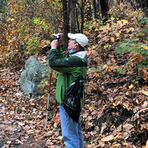 Vinny Variano on a trail in Mohonk Preserve taking a photo