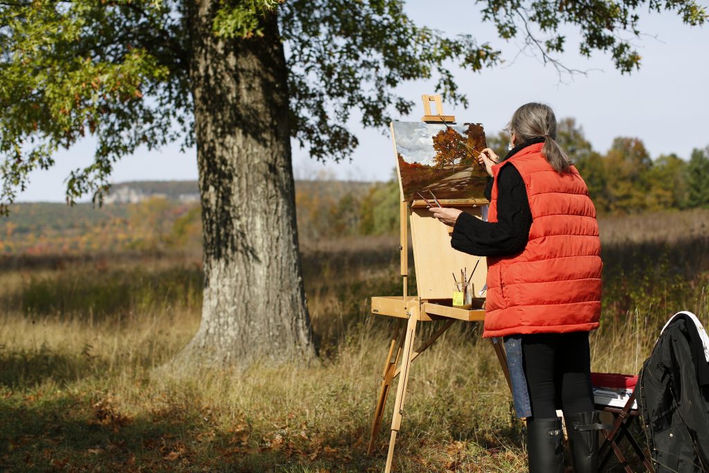 Artist creating a portrait at the Plein Air Art Work eent at Pin Oak Allee in Mohonk Preserve